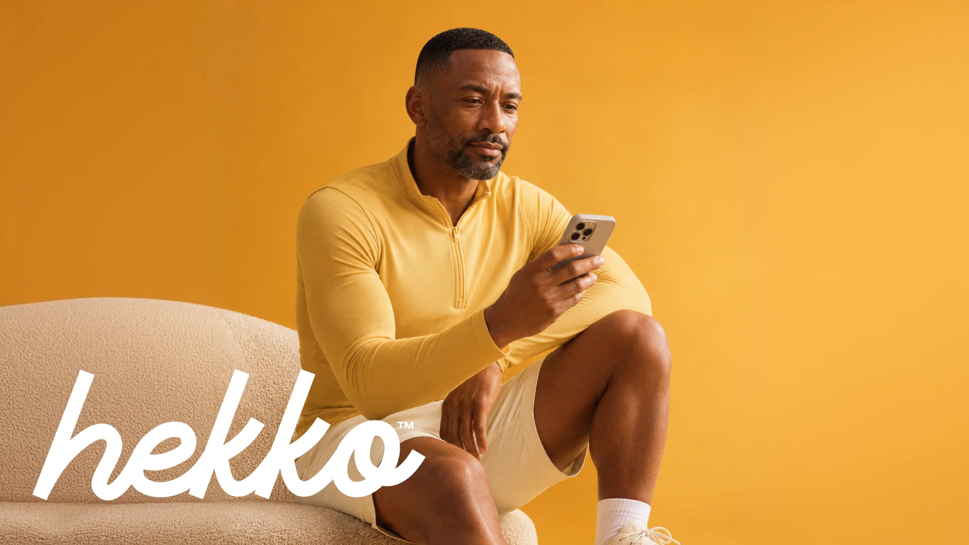 Hekko identity with a man checking his phone on a warm yellow background